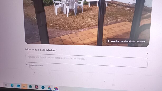 A computer screen displaying a webpage with a photo of outdoor furniture and a garden area.