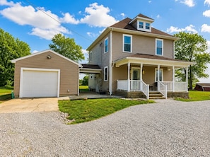 A two-story house with a garage, a covered porch, and a well-maintained lawn. - Spacious 4-bedroom house in quiet Wilmington (Wilmington)