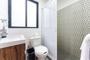 A bathroom with a white sink, toilet, and shower. - 2BR Apartment in CDMX (Ciudad de mexico)