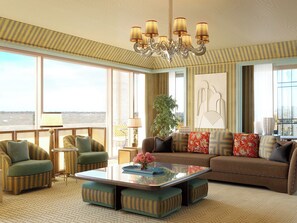 A spacious living room with a large window, a chandelier, and a sofa set. - The Knox, Auberge Collection (Dallas)