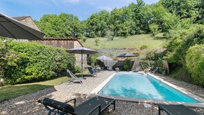 A backyard with a swimming pool, lounge chairs, and umbrellas. - Guest Room “Aubergine” with Shared Pool, Near Sarlat (Proissans)