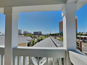 A balcony with a view of a cityscape, including buildings and a clear sky. - The Shore Thing (Panama City Beach)