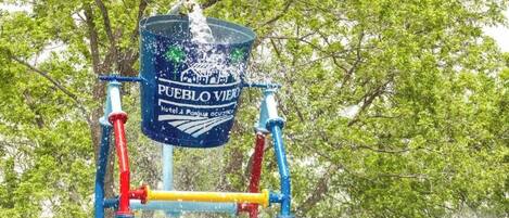 Un área de juegos acuáticos con un cartel que dice 'Pueblo Viejo Hotel & Spa'.