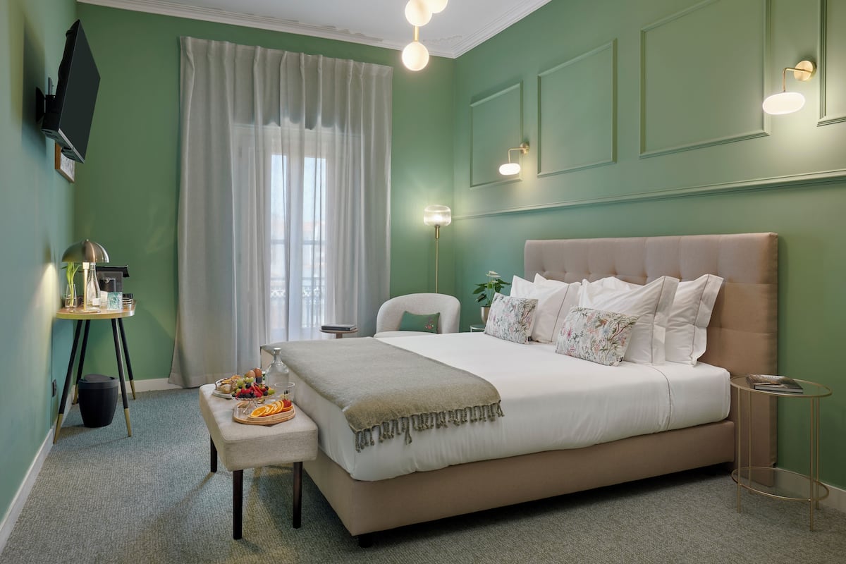 A neatly arranged bedroom with a bed, bedside table, and a small round table.