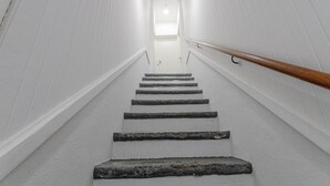 A staircase with stone steps leading to a door at the top.