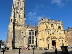 A historic building with a prominent clock tower and detailed architecture. - Meadow Lodge (Cirencester)