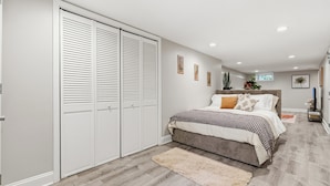 A bedroom with a bed, a closet, a rug, and wall art. - Spacious and furnished 4-bedroom in beautiful Washington, DC. (Washington)