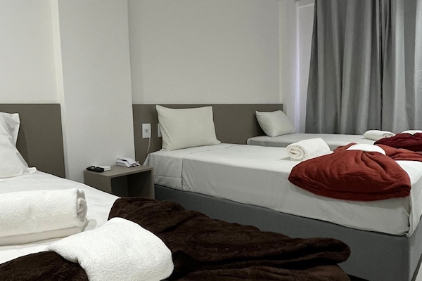Deluxe Triple Room, 1 Bedroom | Desk, laptop workspace, WiFi (free), bed sheets