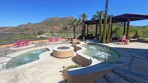 A pool area with hot tubs, lounge chairs, and a pergola with cacti. - Cozy 2 Bedroom Elite Suite at Villa del Palmar Loreto (Ensenada Blanca)