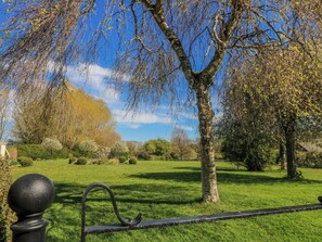 A park with a tree, grass, and a metal fence. - New Barn (Salisbury)