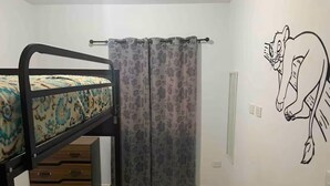 A bedroom with a bunk bed, a curtain, a wall-mounted light switch, and a cartoon character mural. - House with heated pool and 5 min from the pacific ocean (Mazatlán)