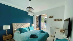 A bedroom with a bed, a nightstand, a lamp, a TV, and a wall with the words 'LOVE DREAM'. - Comfortable house in a quiet location close to the beach (Puget-sur-Argens)