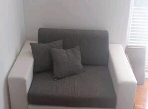 A modern, minimalist living room with a grey sofa and two cushions. - Villa Ivan Vodice -Studio Apartment with Balcony 2 (Vodice)