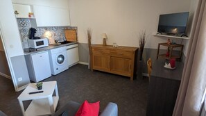 A compact living space with a kitchenette, a washing machine, a dining area with a TV, and a sofa. - 200m from resort center, 3rd floor, balcony, tv, 27m², Orcières Merlette 1850 (Orcières)