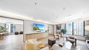A modern living room with a flat-screen TV, comfortable seating, a dining area, and large windows with a city view. - Cozy Skyline Condo - Cityview Miami (Miami)