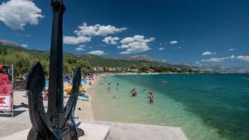 Beach nearby, white sand, beach towels