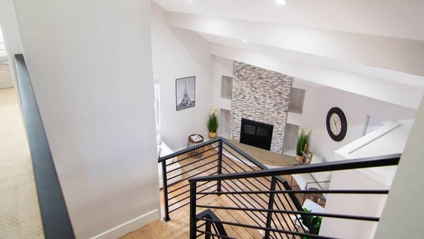 Ein modernes Interieur mit Treppe, Kamin und Essbereich.