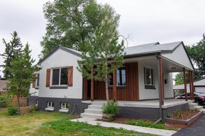 A modern two-story house with a porch, a small front yard, and a driveway. - Charming 4 bed 3 bath home with large yard + more! (Denver)