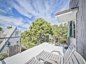 A rooftop patio with a railing, a table, and two chairs. - Spacious Home with Pool Near Townbank Beach (Townbank)