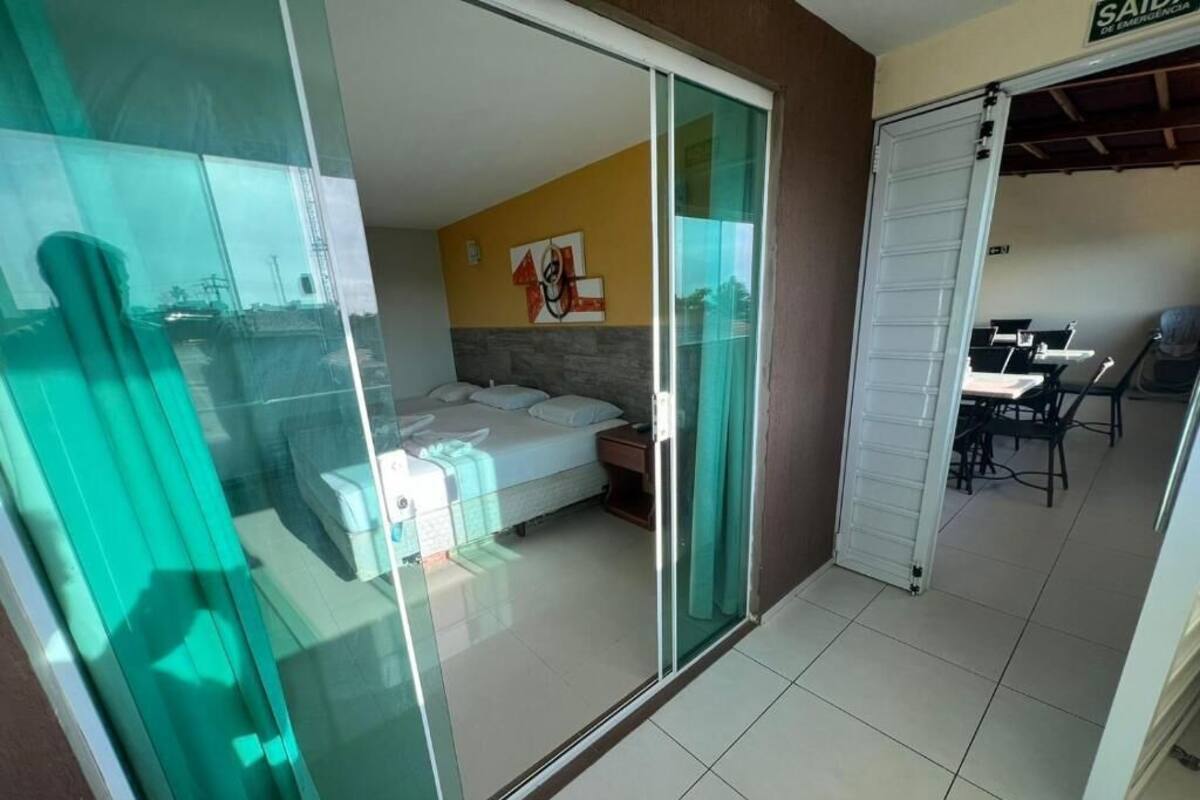 A hotel room with a bed, a desk, and a chair.