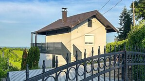Ein Haus mit geneigtem Dach, Schornstein und einem verschlossenen Eingang.