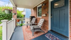 A porch with two chairs, a potted plant, a mailbox, and a door with a number. - Spacious 3BR/2.5BA · Fenced Backyard Oasis · Pets OK (Washington)