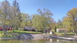 A residential area with a pond, houses, and trees.