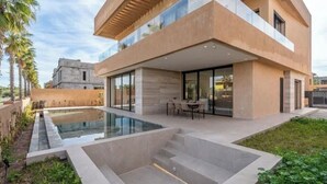 A modern two-story house with a swimming pool, outdoor seating, and a well-maintained garden. - Sumptuous Villa with swimming pool in the secure estate of MYSK Route d'amizmiz (Marrakech)