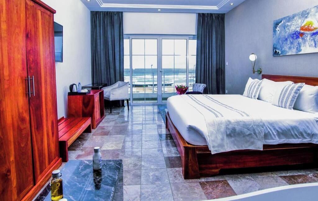 Habitación Deluxe, balcón, vistas a la playa | Minibar, caja fuerte, escritorio y sistema de insonorización
