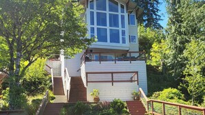 A house with a dock and a small boat. - Amazing Lakefront home on Lake Sutherland, WA (Port Angeles)