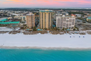 A coastal area with high-rise buildings, a beach, and a clear view of the ocean. - Luxury Beachfront Getaway 3BR Sleeps 10 Pool+ Beach Access (Destin)