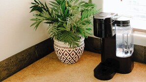 A corner of a room with a potted plant, a coffee maker, and a wall-mounted life preserver decoration. - The Lighthouse - Entire home in Moscow, Idaho (Moscow)