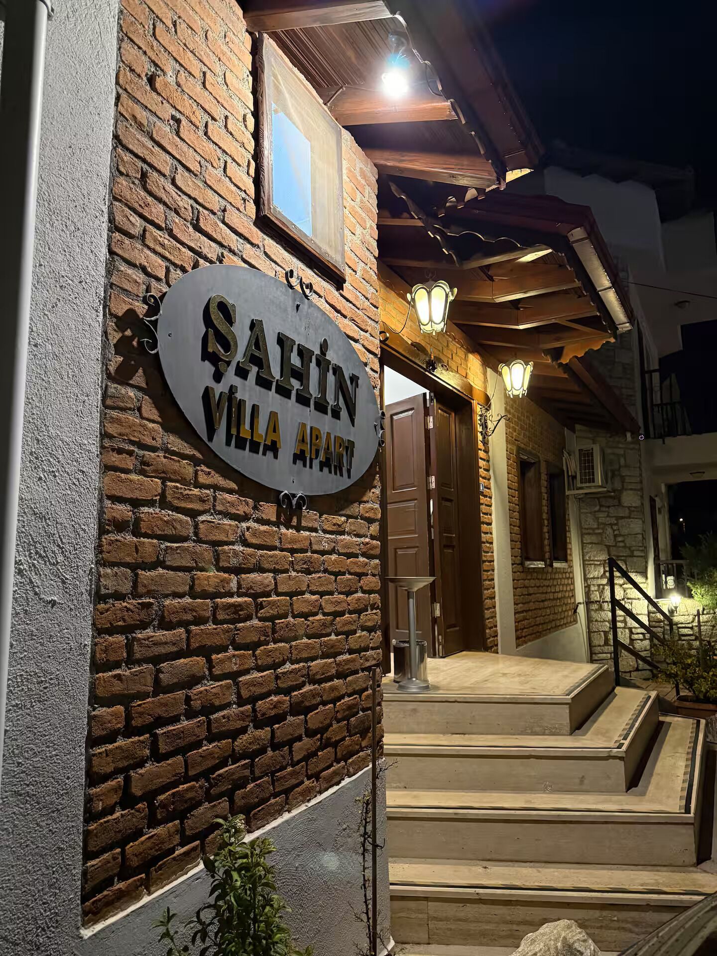 A brick building with a sign reading 'Sahin Villa Apart.'