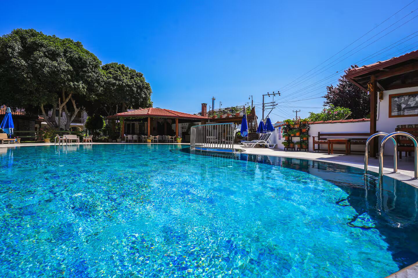 Seasonal outdoor pool, open 7:00 AM to 8:00 PM, pool umbrellas