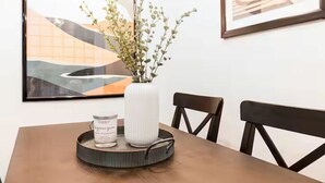 A dining table with a white vase, a tray with a can and a jar, and two chairs. - Entire Rental Unit - Cozy 1 BR/ 1 BA (Atlanta)