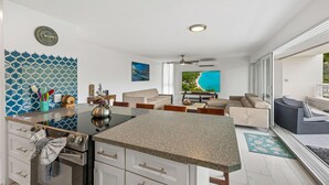 A modern kitchen with a granite countertop, white cabinetry, and a stainless steel kettle. - Generator! 5 mins to Magens + 15 mins to STJ ferry (St Thomas)