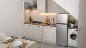 A modern kitchen with a dining area, featuring a built-in stove, sink, and washing machine. - le casette marconi (Peschici)