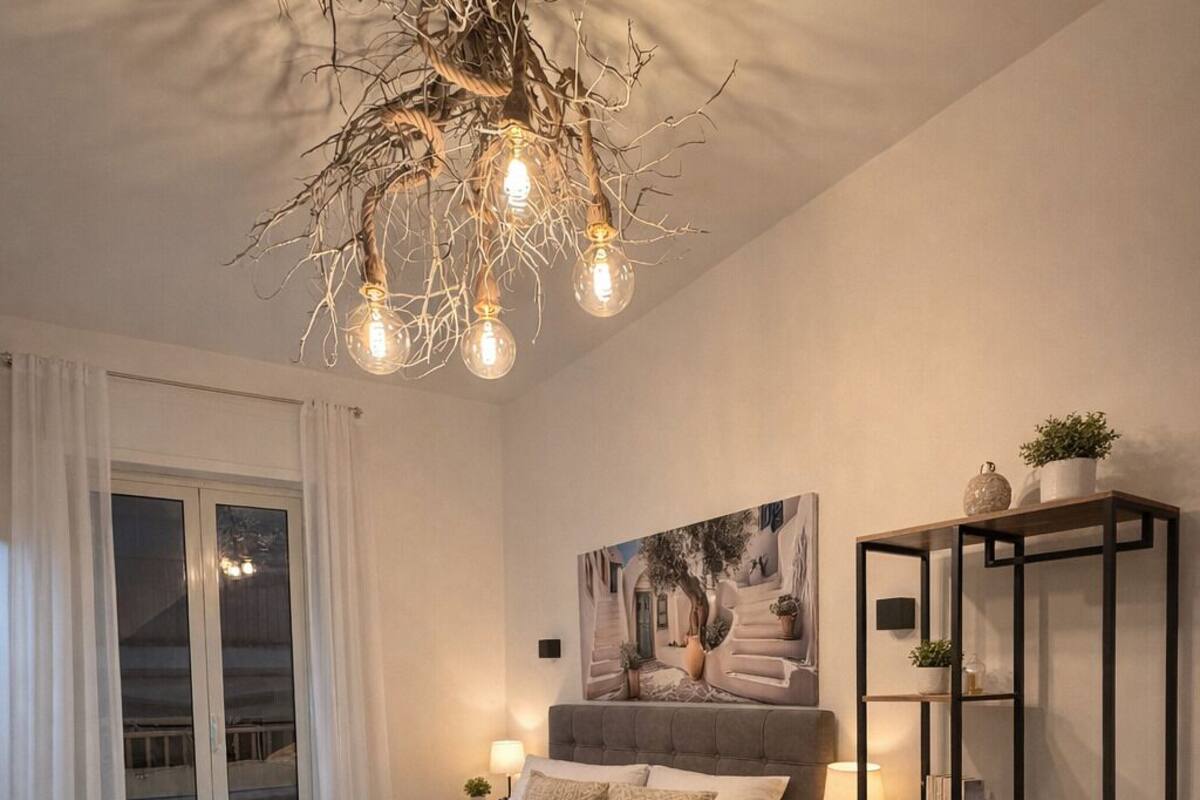 A modern bedroom with a bed, bedside tables, a desk, and a chair.