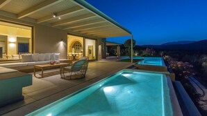A modern outdoor pool area with a covered seating area, a dining table, and a lounge chair. - Villa Marat - Four Bedroom Villa, Sleeps 8 (Astratigos)