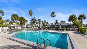 A rectangular swimming pool with a metal ladder, surrounded by lounge chairs and palm trees, with buildings in the background. - ALL NEW - Resort Amenities and Beach Access (Siesta Key)