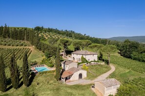 A villa with a swimming pool, surrounded by vineyards and trees. - Casale Eleganza - Five Bedroom Villa, Sleeps 10 (San Gimignano)