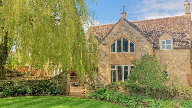 A stone house with a large window and a weeping willow tree in the foreground. - Abbeville Barn - Four Bedroom Villa, Sleeps 11 (Langford)