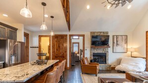 A spacious kitchen with a marble countertop, wooden cabinets, and a built-in refrigerator. - True Blue 92 at Eagles Nest - 3 King Suites, Deck Fire Table, Firepit (Banner Elk)