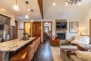 A spacious kitchen with a marble countertop, wooden cabinets, and a built-in refrigerator. - True Blue 92 at Eagles Nest - 3 King Suites, Deck Fire Table, Firepit (Banner Elk)