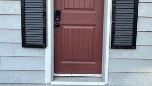 A red door with a mailbox, a mailbox, and a doorbell. - Cozy Apartment Little Rock Pets Welcome (Little Rock)