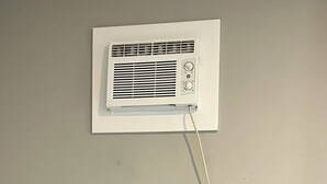 A wall-mounted air conditioner and a television. - Cozy Apartment Little Rock Pets Welcome (Little Rock)