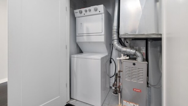 A compact utility room with a water heater, a control panel, and a vent system. - Charming 2-bedroom Apartment in Royal Oak (Royal Oak)
