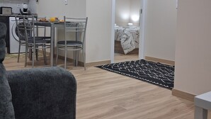 A compact living space with a kitchenette, a dining area, and a bedroom. - Arco-Íris, Ponta do Sol (Ponta do Sol)