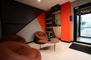 A modern interior with a sofa, a small table, and a plant.