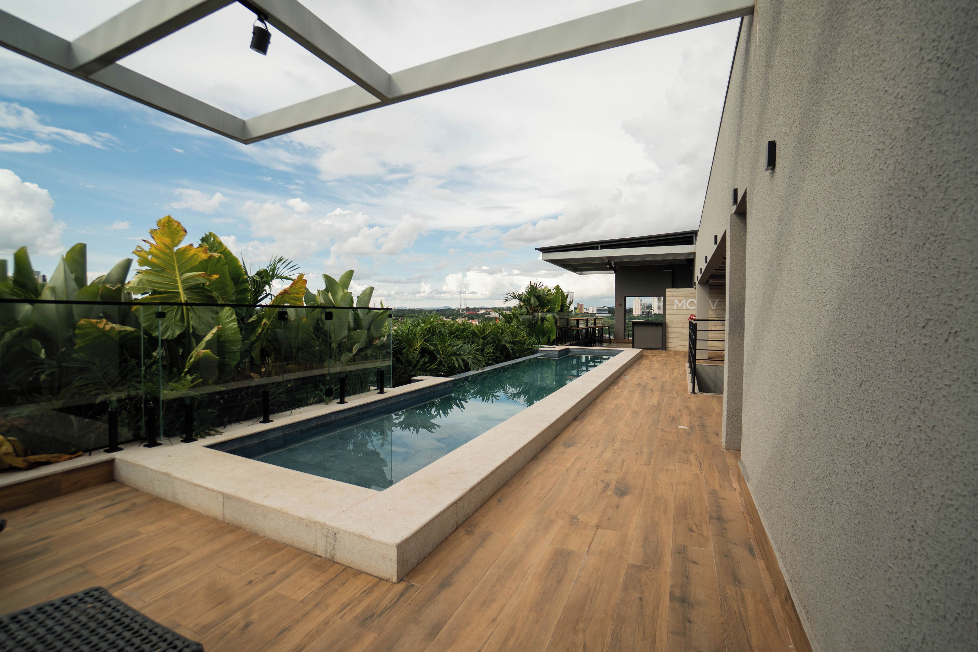 A rooftop pool area with a clear view of the sky and surrounding buildings.